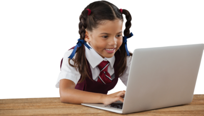 Schoolgirl using laptop at desk