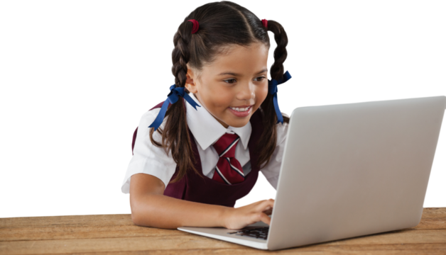 Schoolgirl using laptop at desk - Powered by Adobe