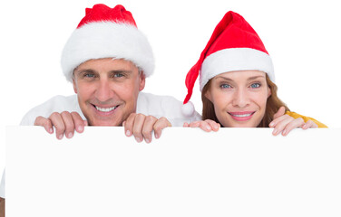 Festive couple showing a poster