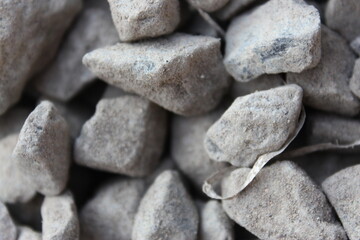 close up of grey stone pebbles as a background, macro