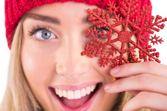 Happy blonde holding red snowflake