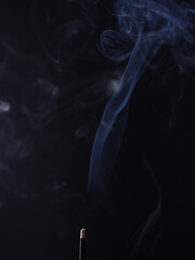 Obraz premium Burning aromatic incense smoky stick for meditation and relaxing. Aromatherapy smoke for yoga concept