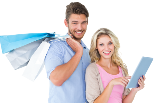 Attractive young couple holding shopping bags using tablet pc