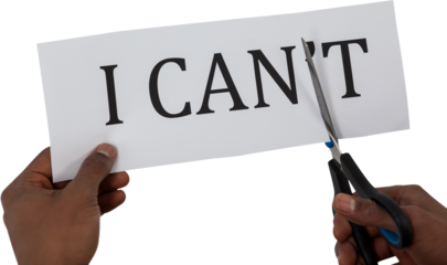 Conceptual image of businessman cutting paper that reads we cant 