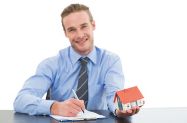 Real estate agent holding model house while writing on clipboard