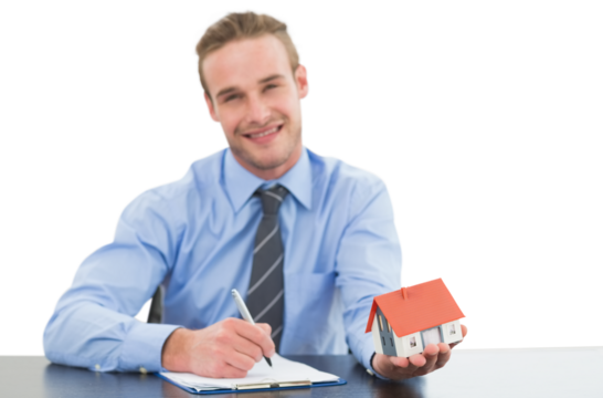 Real estate agent holding model house while writing on clipboard