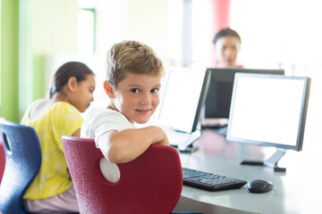 Smiling boy using computer