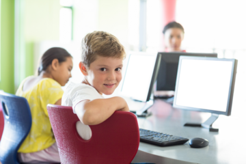 Smiling boy using computer