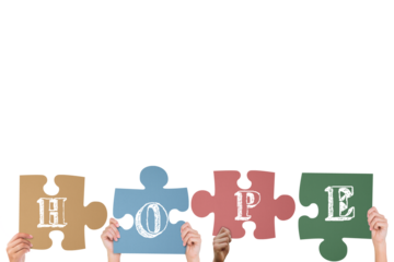 Hands holding up hope jigsaw pieces