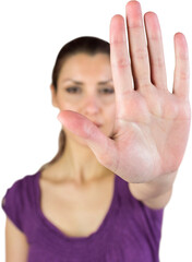 Portrait of woman showing stop sign