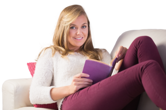 Pretty blonde relaxing on the couch with book