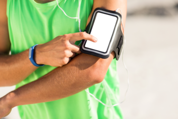 Midsection of man using smart phone on armband