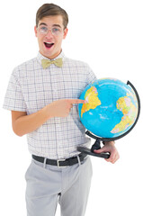 Geeky hipster holding a globe smiling at camera