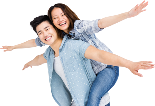 Portrait of happy couple with arms outstretched - Powered by Adobe