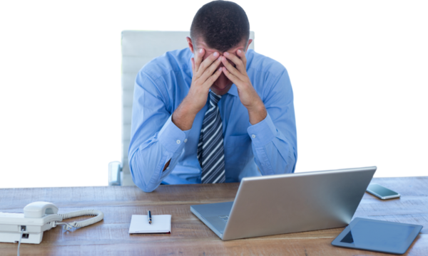 Worried businessman with head in hands 