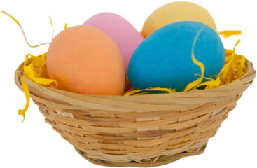 Colorful Easter eggs in wicker basket 