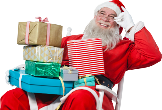 Cheerful Santa Claus holding Chritmas presents while sitting on chair