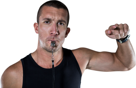 Portrait of attentive trainer blowing his whistle