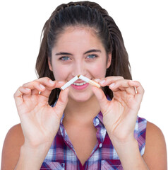 Smiling woman snapping a cigarette over white background