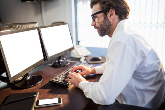 Businessman with glasses working on computer 