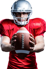 Portrait of American football player holding ball