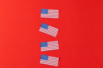 High angle view of four flags of united states of america with copy space on red background