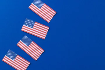 Keuken foto achterwand Centraal-Amerika  High angle view of four flags of united states of america with copy space on blue background