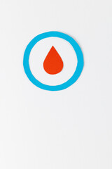 Fototapeta premium Blood drop in blue ring on white background with copy space