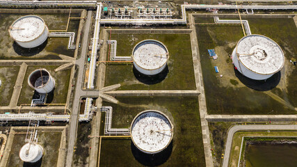Aerial drone of large above ground tanks store oil and gas in an oil refinery. Borneo, Sabah, Malaysia.