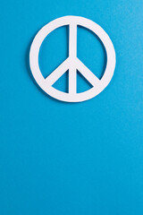High angle view of white peace sign with copy space on blue background