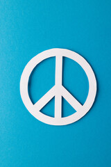 High angle view of white peace sign with copy space on blue background