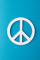 High angle view of white peace sign with copy space on blue background