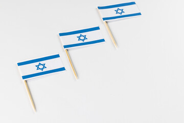 Close up of three flags of israel with copy space on white background