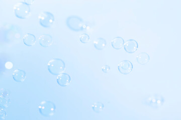 Fototapeta na wymiar Beautiful Transparent Blue Soap Bubbles. Blurred Abstract White Background. Soap Sud Bubbles Water.