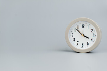 Alarm clock on gray scene, time concept operation of time When it's important to work and live