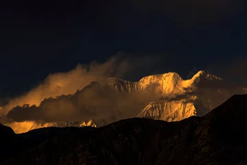 Cercles muraux Nanga Parbat beautiful sunset over snow mountains with clouds and blue sky , snow mountains in golden light during sunset 