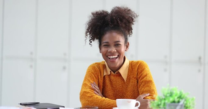 Young African American businesswoman working with pile of documents at office workplace, business finance and accounting concepts.