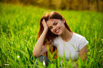 Beautiful young woman close up portrait among green cereal grass