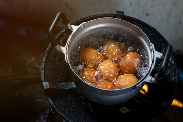 Saucepan with boiling eggs on a gas stove in the morning