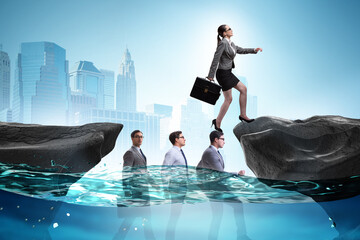 Inequal competition concept with businesswoman walking on heads