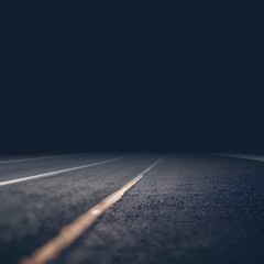 Black asphalt road goes into night solid darkness. Textured surface closeup defocus illustration. Toned empty background.