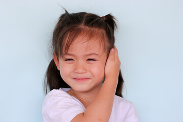 The girl gestures with her hands covering her ears.