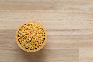 Top view of split soybeans in a bowl on wooder background, Healthy eating concept