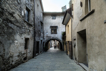 Fototapeta na wymiar Bard, Italy. Ancient buildings in the historic center of the ancient village. View from Via Vittorio Emanuale II. 2023-03-25.