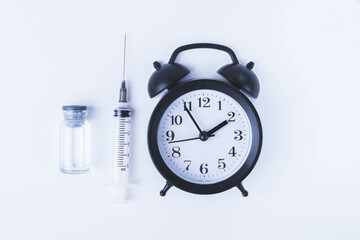 Time for vaccination. Watch and syringe with vaccine. Date and time of preventive vaccinations to...