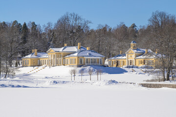 The main building and the library outhouse of the old Monrepos estate on a sunny March day. Vyborg, Leningrad region. Russia