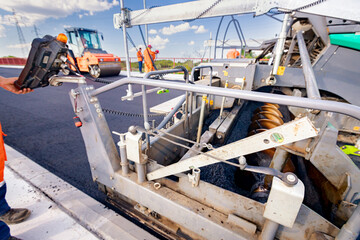 Spirit level at construction site attached on the asphalt spreader, tarmac road laying machine