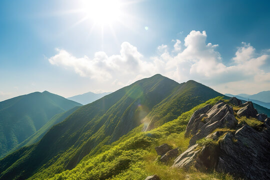 Beautiful sunrise over the green mountains in morning light with fluffy clouds on a bright blue sky. Nature freshness concept