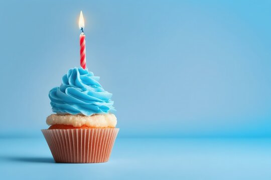 cupcake with candle, birthday cupcake with red candle on light blue background