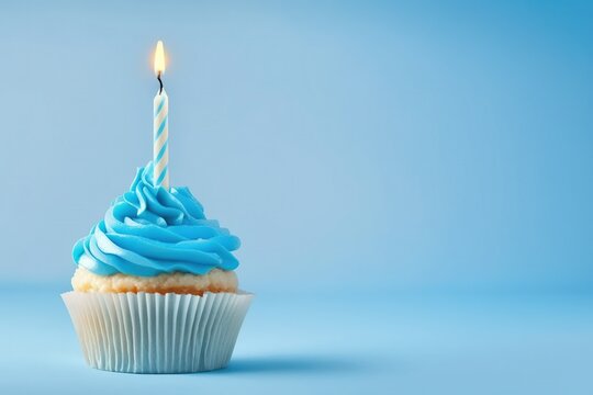 cupcake with candle, birthday cupcake with light blue candle on light blue background